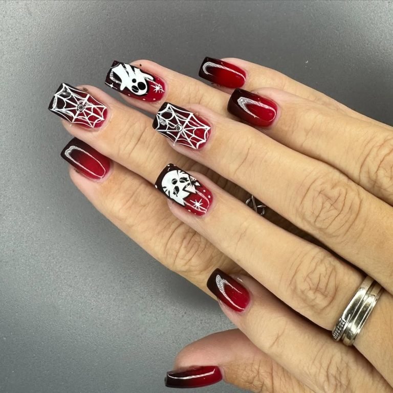 Dark Halloween nails in blood-red and black with white spider webs, a Scream ghost face, and a skull design on long coffin-shaped nails