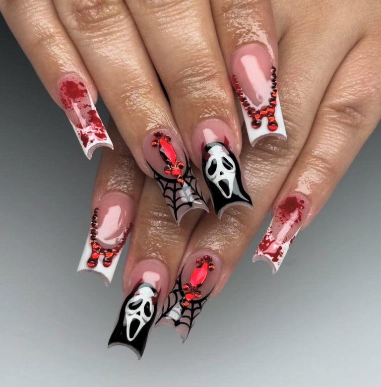 Barbiecore Halloween nails with dripping blood, spiderwebs, a Ghostface mask design, and crimson rhinestones tracing deep French tips