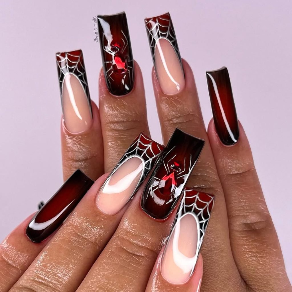 Floating Spider Decals Nail Ideas with a deep red gradient, red crystal 3D spiders, and delicate white webs on a sharp coffin shape