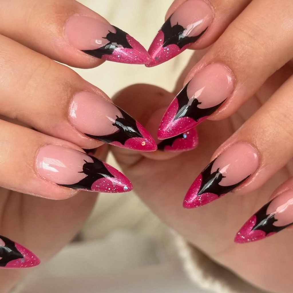 Hot pink French tip nails with black bat silhouette nail art for Halloween