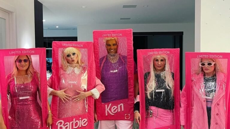 Group Halloween costume of five friends dressed as boxed Barbie and Ken dolls in pink cardboard packaging