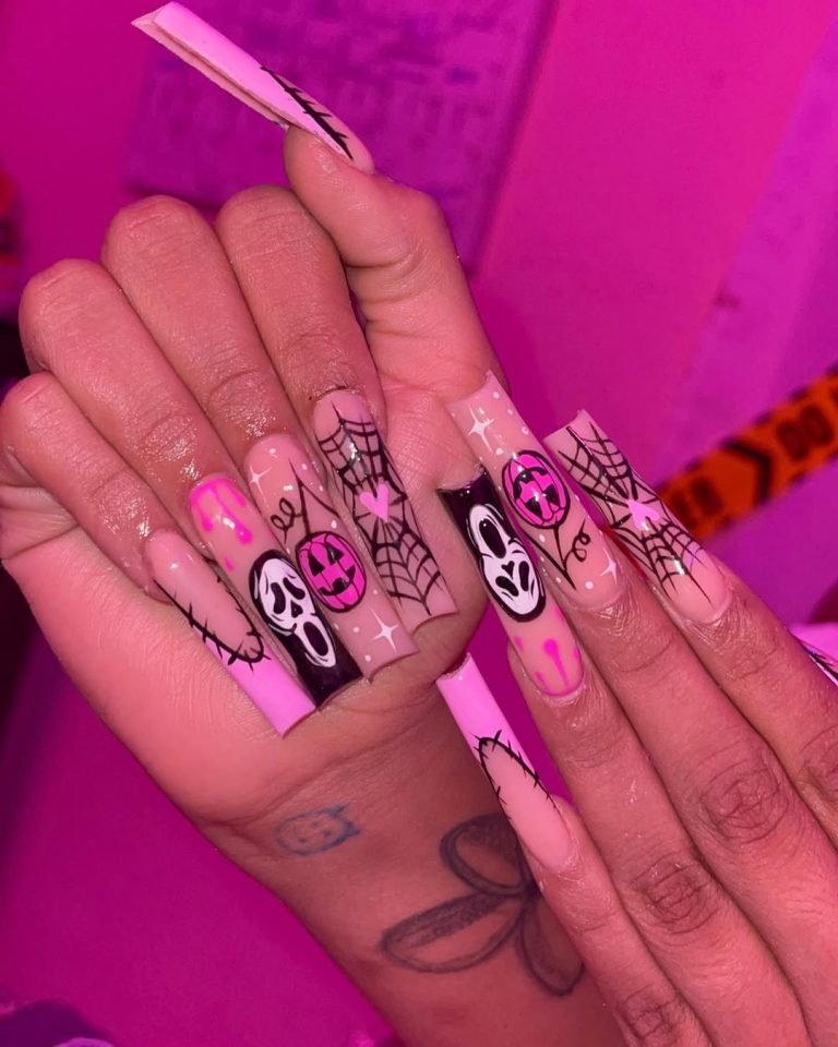 Long hot pink Halloween nails featuring scream masks, jack-o'-lanterns, and black spiderwebs against a neon pink base
