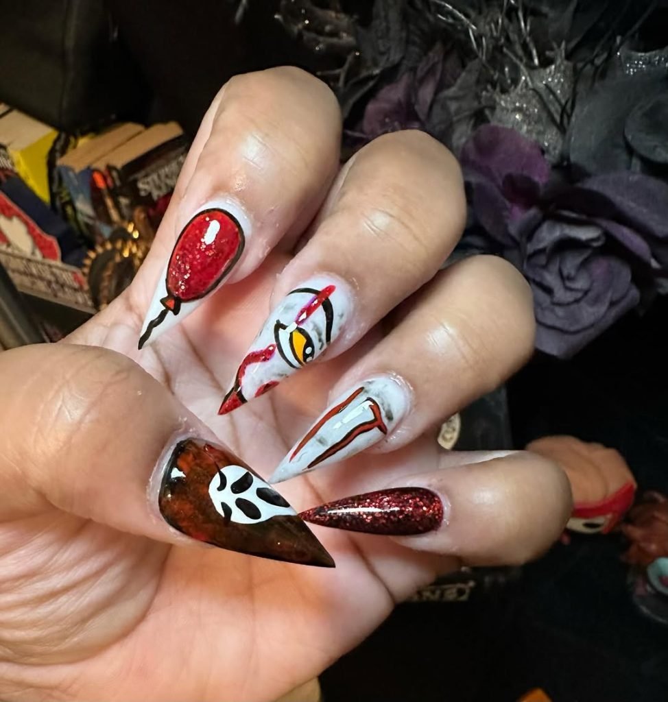 Almond-shaped horror Halloween nails hand-painted with recognizable movie villain faces including Ghostface, Jason, Michael Myers, Freddy, Leatherface, and Pennywise on a dark base.