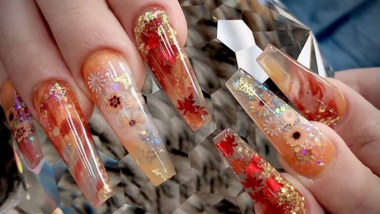 Glitter Thanksgiving nail art with red maple leaf details and gold glitter on long coffin nails