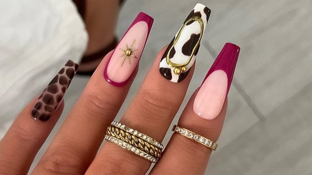 Fuchsia French tip nails with cow print, leopard print, and gold star accents