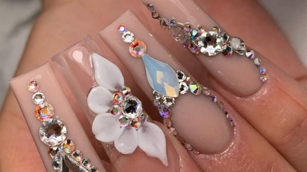 Close-up of bridal nails with rhinestone lines and a white 3D flower, styled for a Thanksgiving wedding