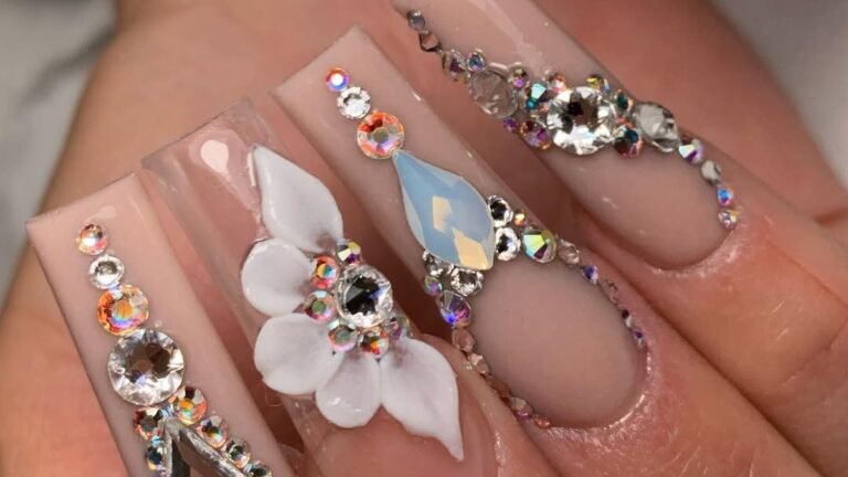 Close-up of bridal nails with rhinestone lines and a white 3D flower, styled for a Thanksgiving wedding