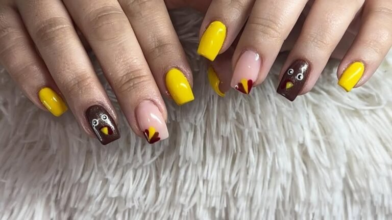 Bold yellow and brown nails with hand-painted turkey faces and red and yellow feather fan French tips