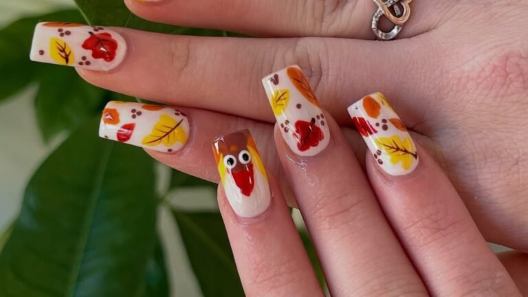 Nail art featuring a hand-painted turkey face nail alongside autumn leaf and berry designs, part of a Thanksgiving-themed manicure set