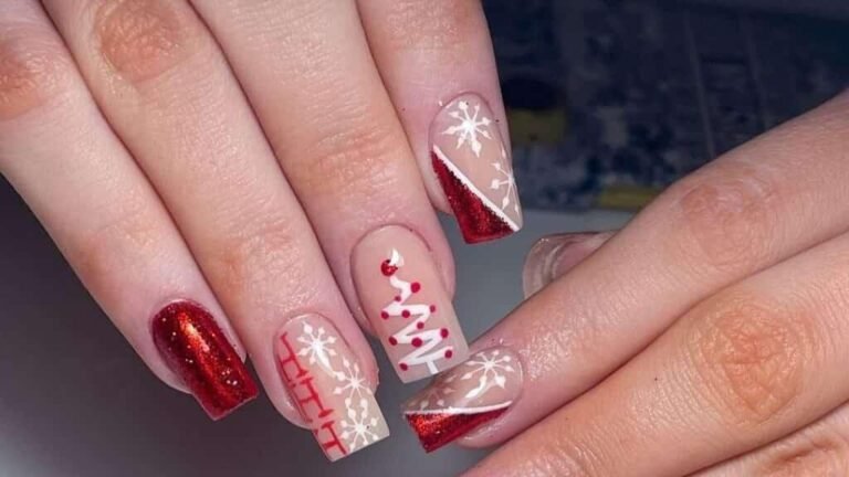 Red Christmas manicure with matte nails, a glitter accent nail, and a hand-painted snowflake design on a pink and red tip