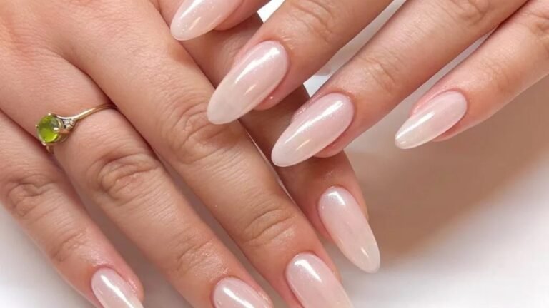 Almond French manicure with white tips and a single pearl dot centered on each pink nail base