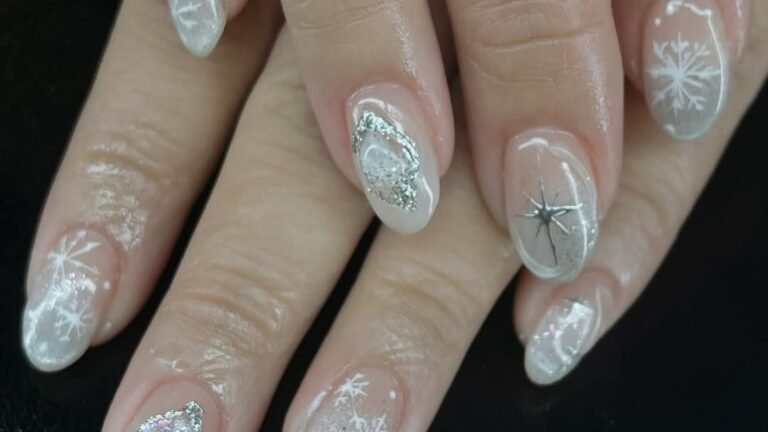 Soft white snowflake and star nail art on clear glazed nails, a soft December manicure idea