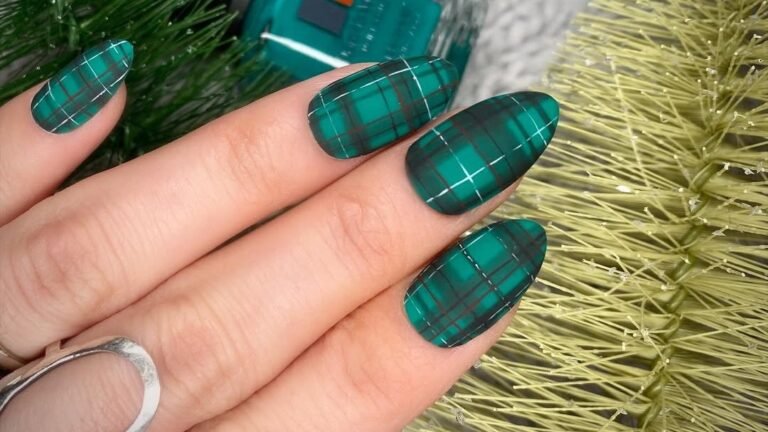 Emerald green tartan plaid nail art design with white and rust grid lines, one of several winter plaid nail ideas