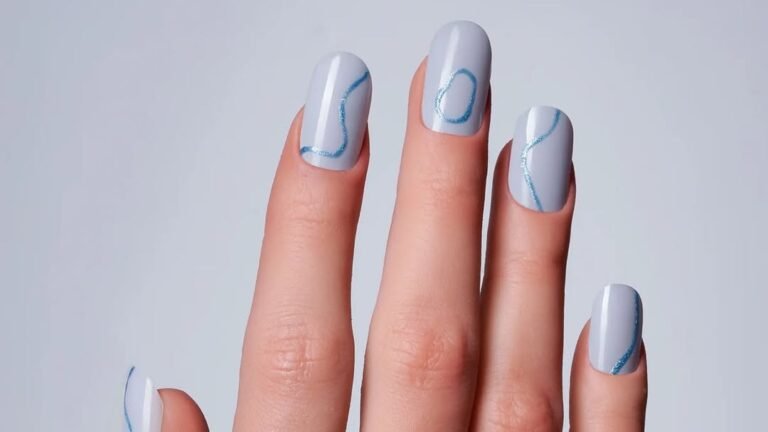Pale blue minimalist manicure with one thin metallic line accent across each nail