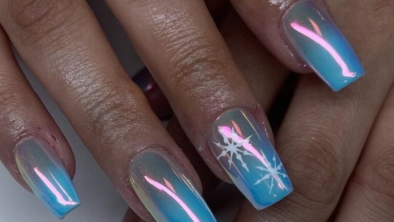 Aurora chrome nail art in blue and pink with a white snowflake design on one accent nail