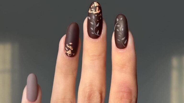Matte mocha brown Thanksgiving nails with rose-gold foil accent and white vine nail art