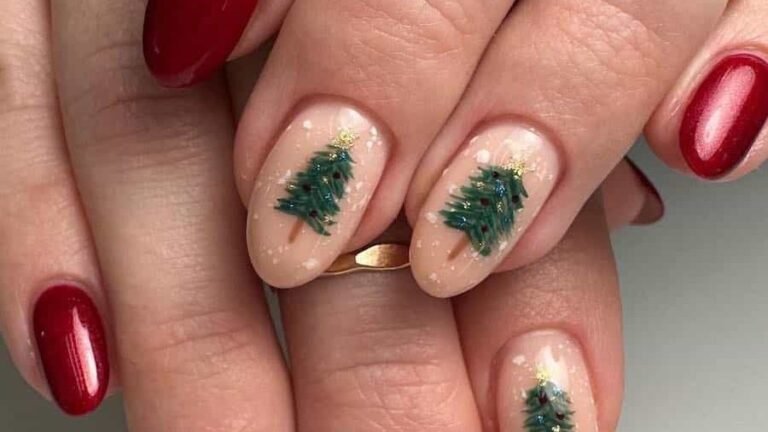 Nude nails with tiny hand-painted Christmas trees next to bold red nails, an example of Christmas nail ideas that skip the full paint job