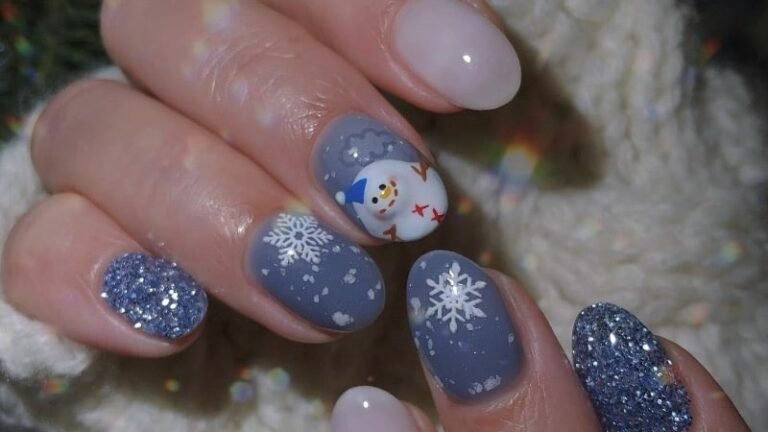 Grey Christmas manicure with glitter nails, snowflake nails, and one 3D snowman nail