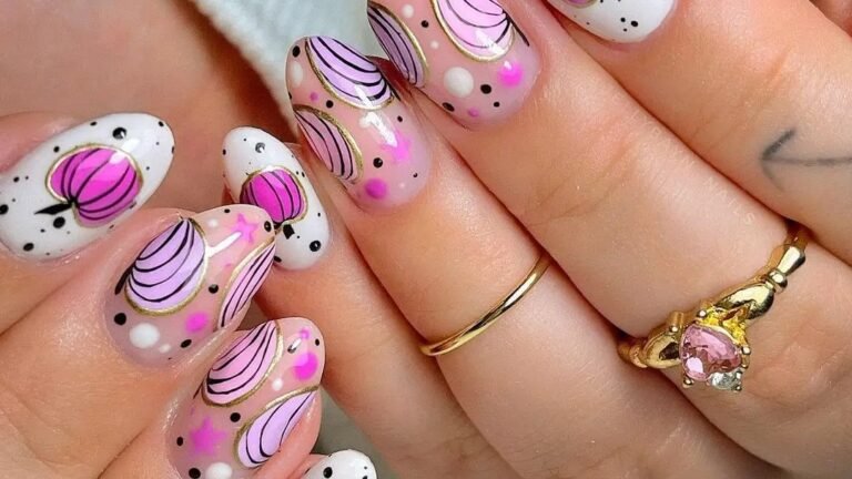 Pink Thanksgiving pumpkin nail art with gold outline detailing and black polka dots on white and nude polish