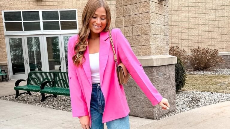 Woman smiling in an oversized hot pink blazer over a white tank top and denim jeans, one of 12 casual February outfit ideas