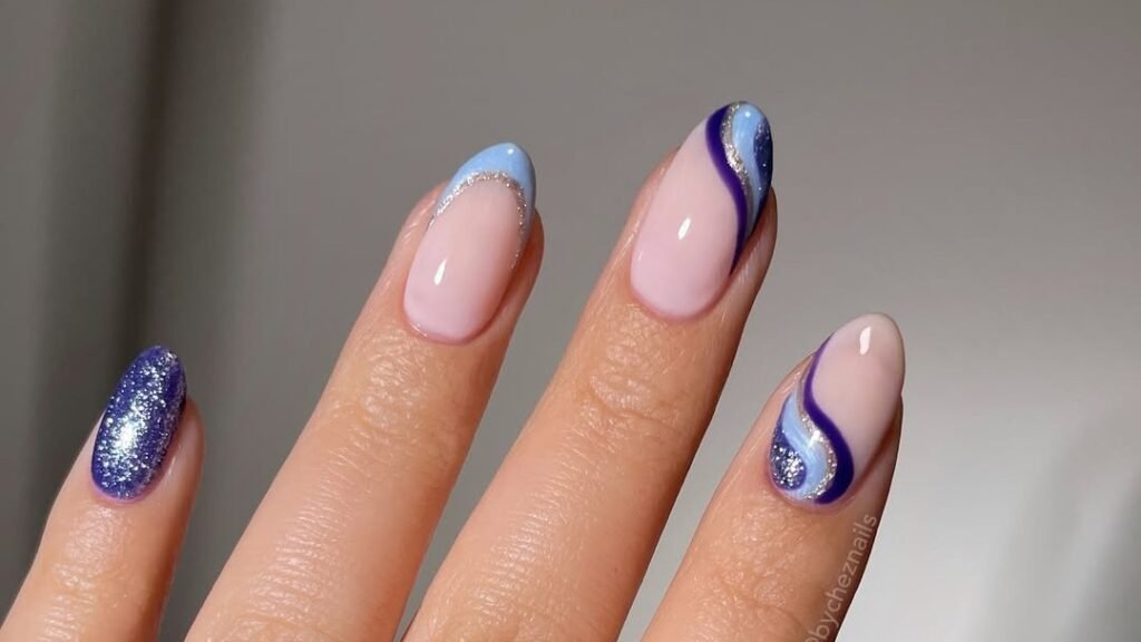 Purple and blue wave nail art on bare nude nails with silver glitter accents