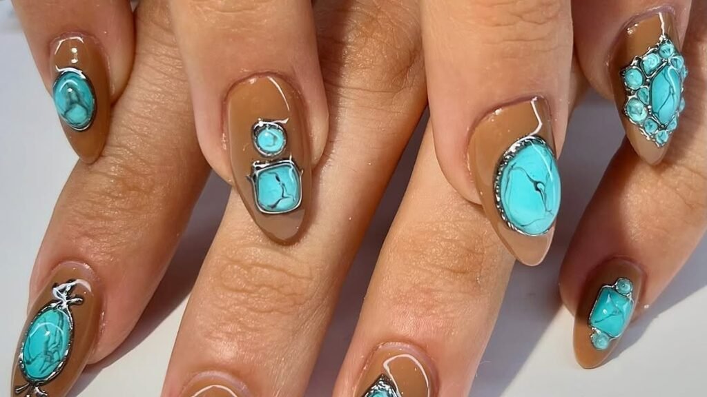 Almond-shaped nails with a glossy caramel brown base, each decorated with turquoise stones set in silver frames, including a large oval, a stacked round and square pair, and a cluster of small stones.