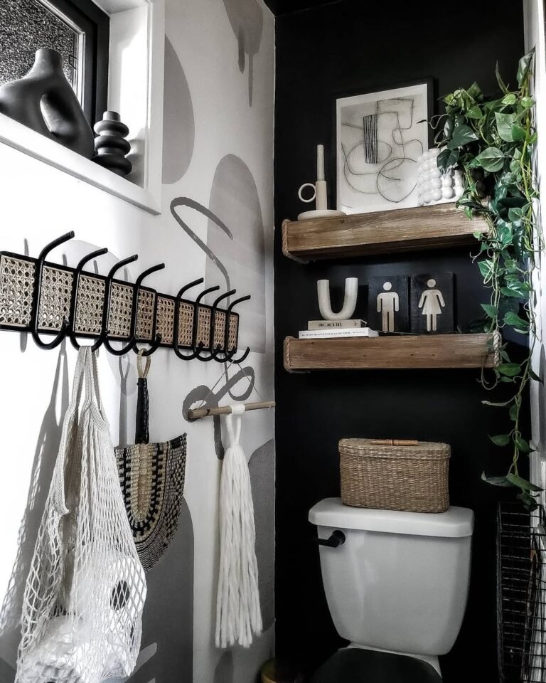 Bathroom wall with a bold patterned backdrop and a long row of evenly spaced hooks holding towels, turning storage into a design feature