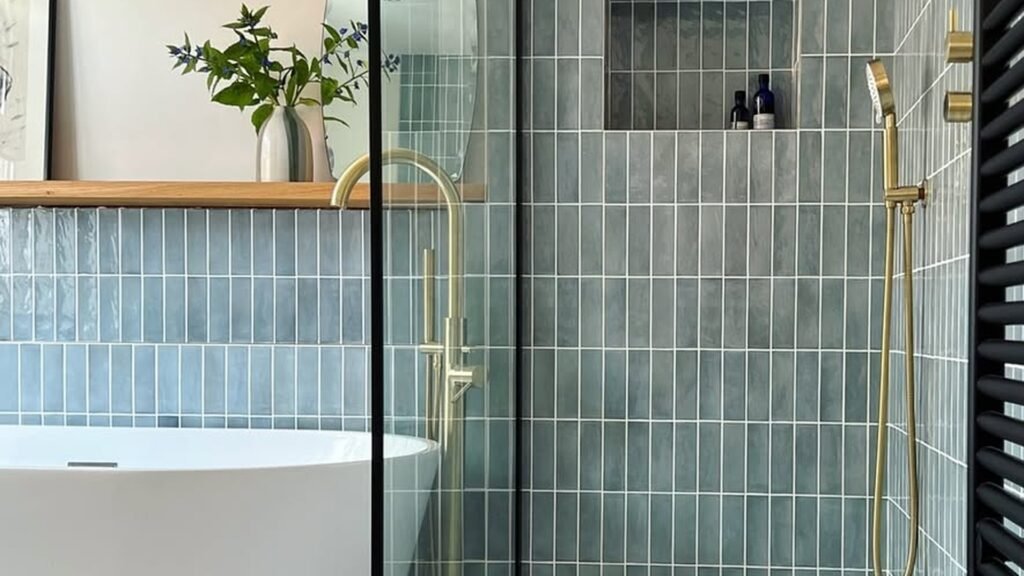Blue-green vertical tile walk-in shower with a brass rain head, a recessed niche, and a curbless step-in tray, no tub to climb over