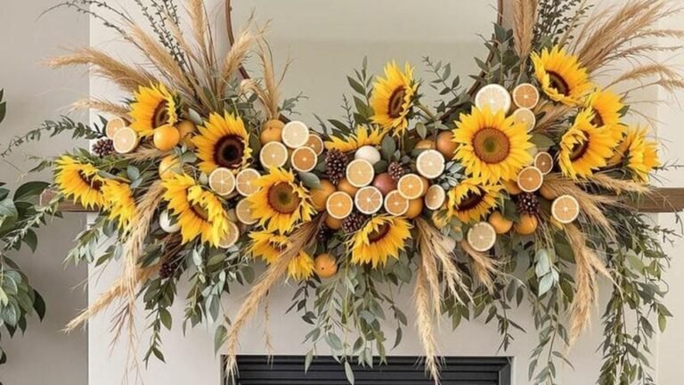 Fireplace mantel decorated for fall with sunflowers, dried citrus slices, and pampas grass in warm gold and orange tones