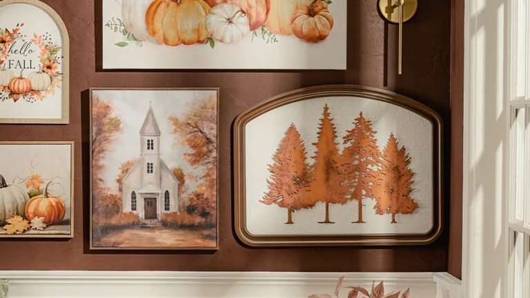 Fall gallery wall with framed pumpkin art, church painting, and copper tree prints on a deep brown wall