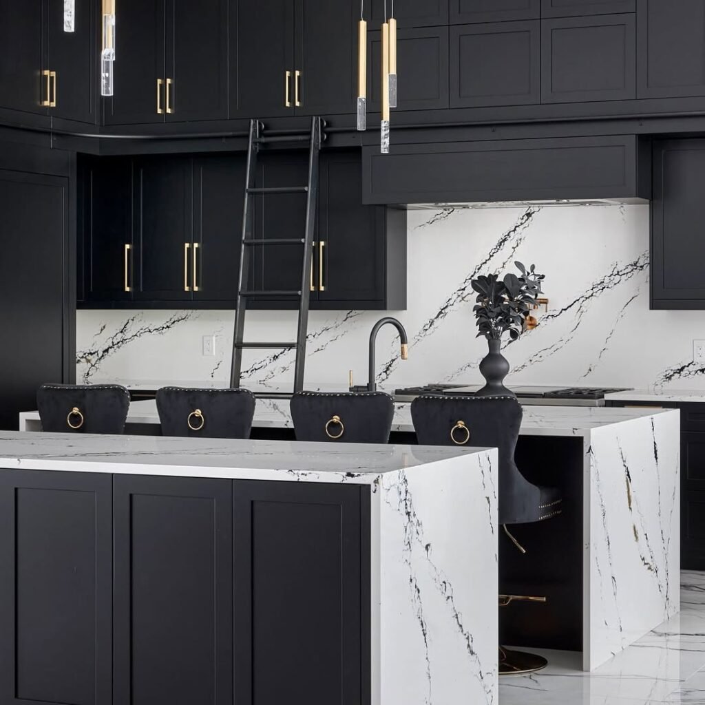 Black and white kitchen with floor-to-ceiling dark cabinetry, a black marble island, white marble backsplash, brass ring-pull hardware, and a rolling library ladder.