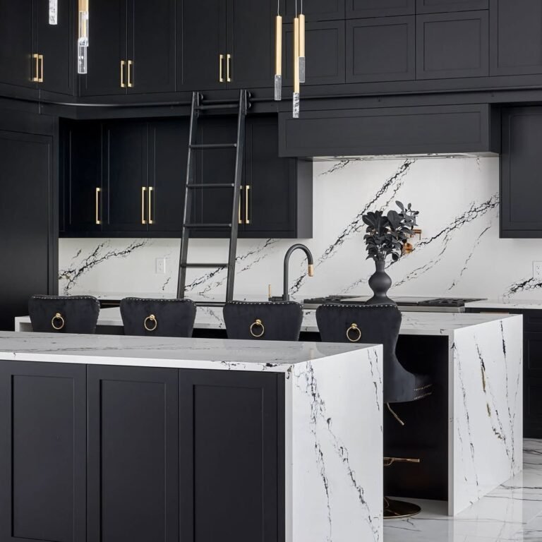 Black and white kitchen with floor-to-ceiling dark cabinetry, a black marble island, white marble backsplash, brass ring-pull hardware, and a rolling library ladder.