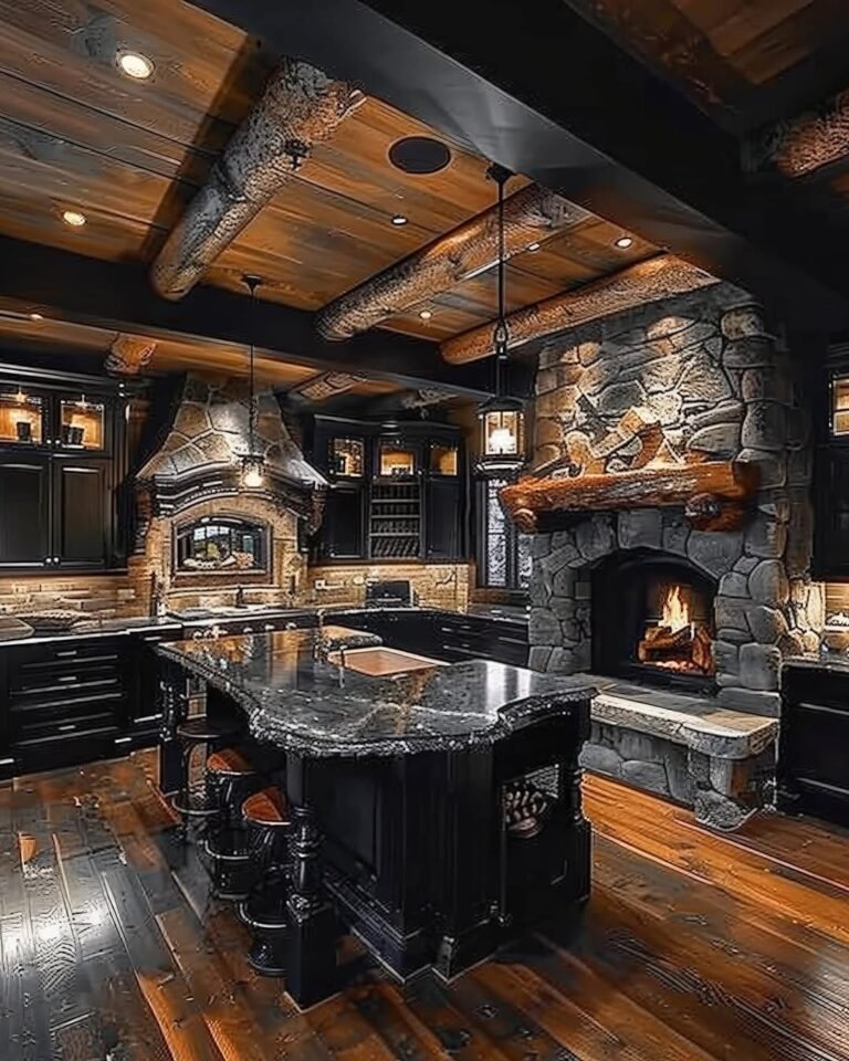 Black kitchen with dark cabinetry, a marbled island, reclaimed timber beams, and a glowing stone fireplace lit by lantern pendants