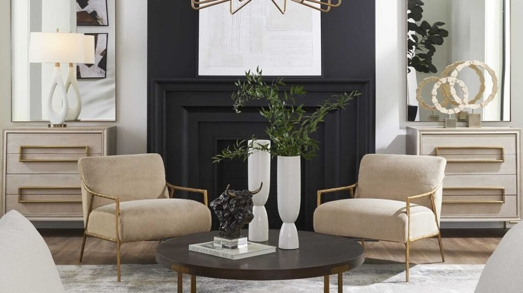 Gold sunburst chandelier over a living room seating area with taupe armchairs, arched mirrors, and a black accent wall