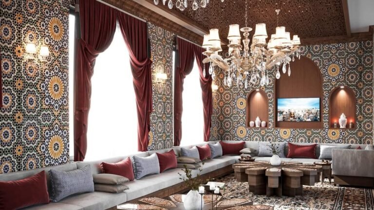 Moroccan living room with gray bench seating built into a mosaic tiled wall, red velvet curtains, and crystal chandeliers