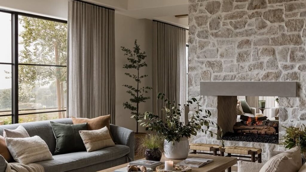 Rectangle living room with two sofas clustered on a rug facing a stone fireplace wall, open floor space at the room's edges