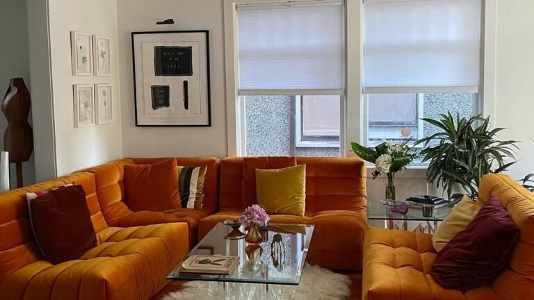 Burnt orange velvet sunken sectional sofa fills a plain living room, proving one bold color choice can replace a full remodel
