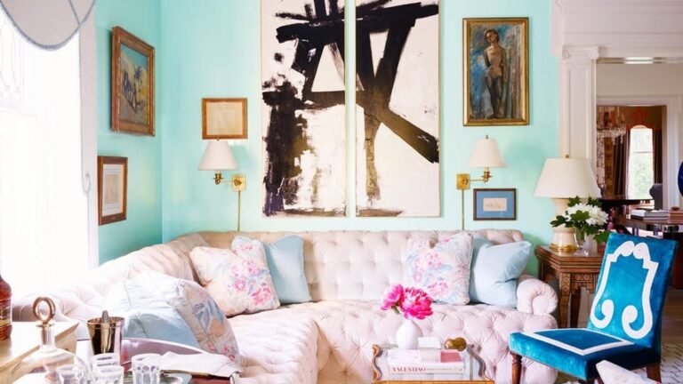 Tufted pink sofa in a glamorous Tiffany blue living room with bold black and white art