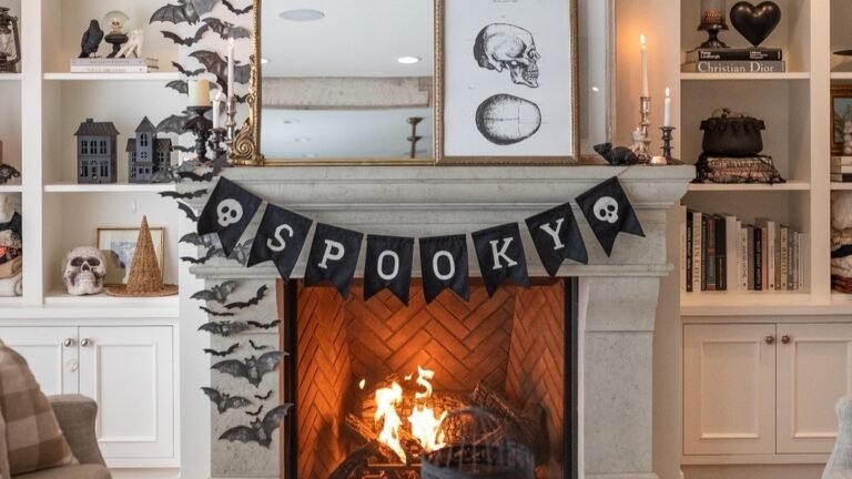 Black paper bats flying diagonally up a white bookshelf wall beside a mantel with a gold mirror, skull print, and "SPOOKY" banner