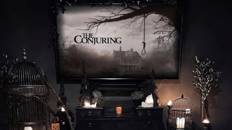 Dark gothic living room with The Conjuring movie poster above a black dresser, flanked by candlelit birdcages, styled as Halloween decor