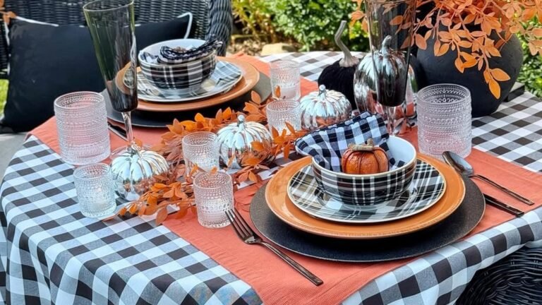 Black and white buffalo check tablecloth set with plaid dinnerware, metallic pumpkins, and orange runner for a Thanksgiving table
