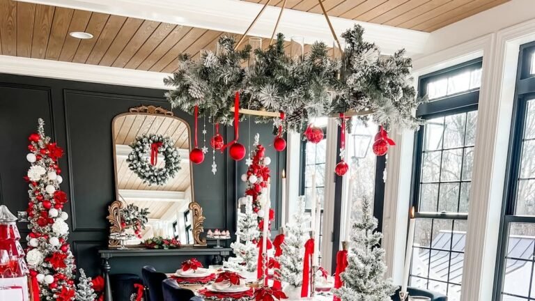 Flocked chandelier decorated with hanging red ball ornaments above a Christmas dining table