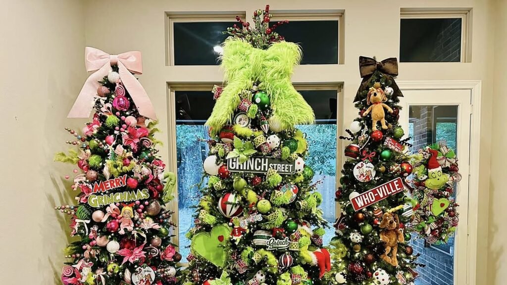 Three decorated Grinch Christmas trees side by side, a pink and lime tree with a big pink bow, a center tree with a fuzzy lime green bow topper and a Grinch Street sign, and a right tree with a Who-Ville sign and plush Max ornaments.